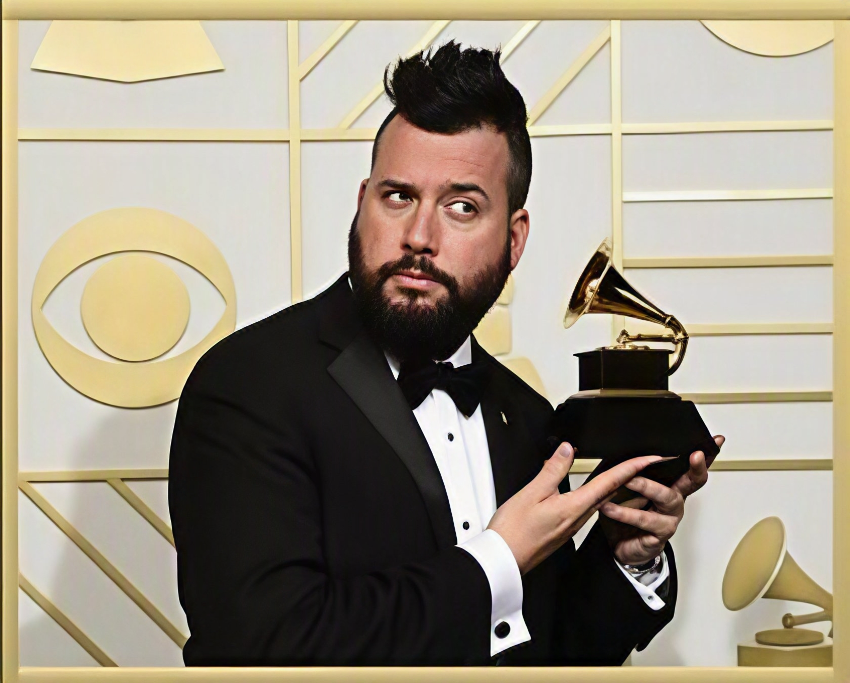 Dave Audé holding a GRAMMY Award.